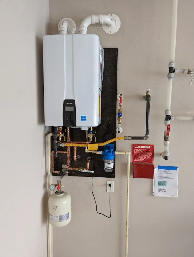 Professional plumber installing copper piping in a Standish home